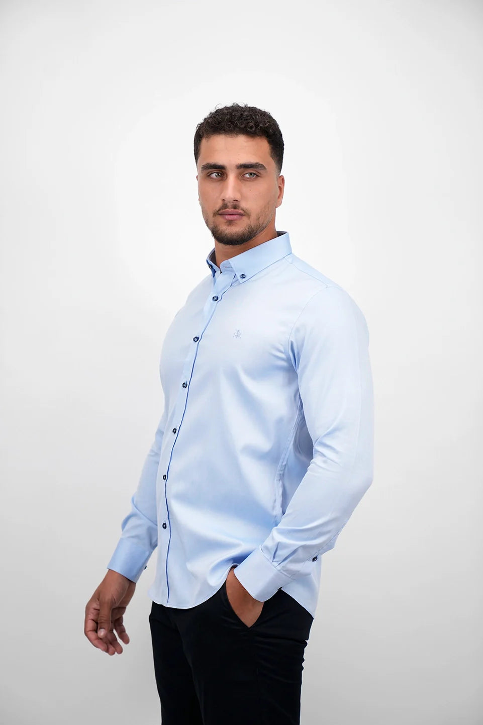 Blue Long Sleeved Shirt With Black Button To Close